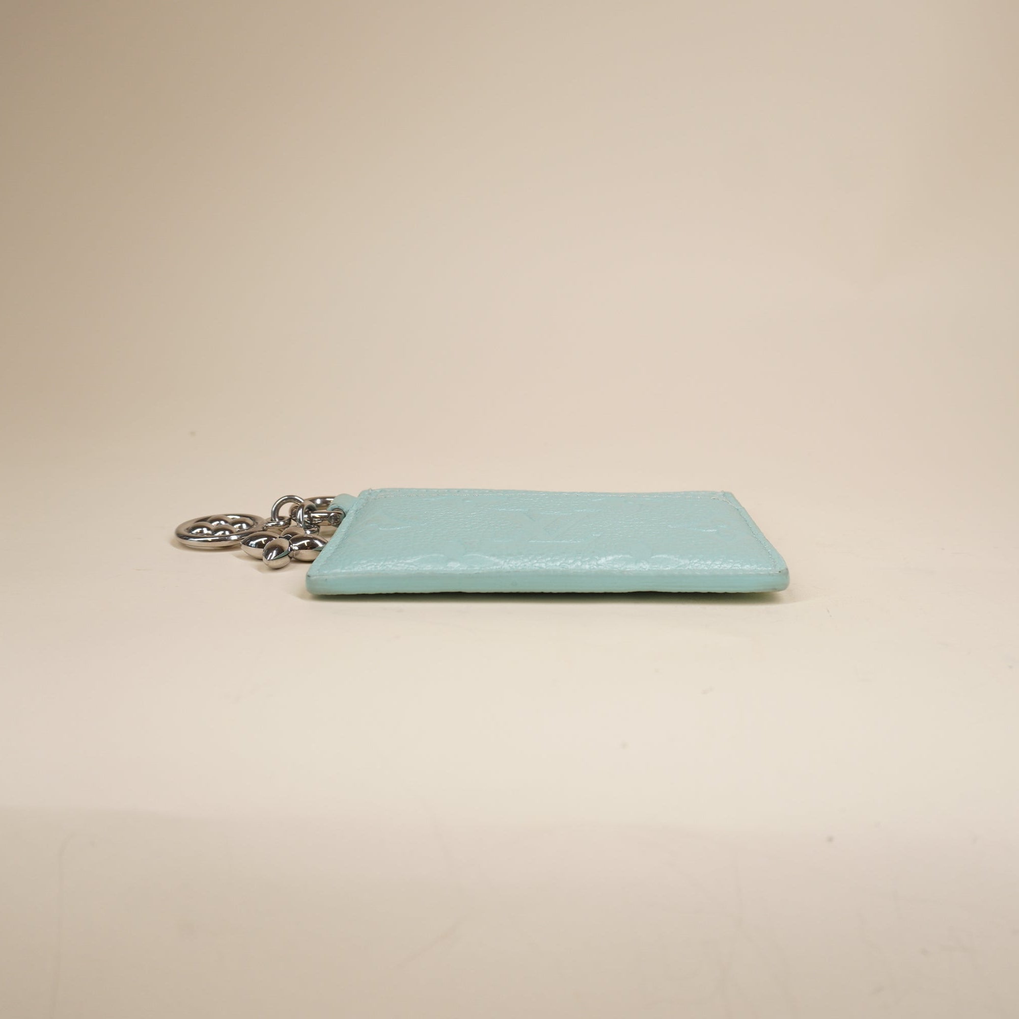 PRE-OWNED LV Lagoon Turquoise Empreinte Monogram LV Charms Card Holder Pearly