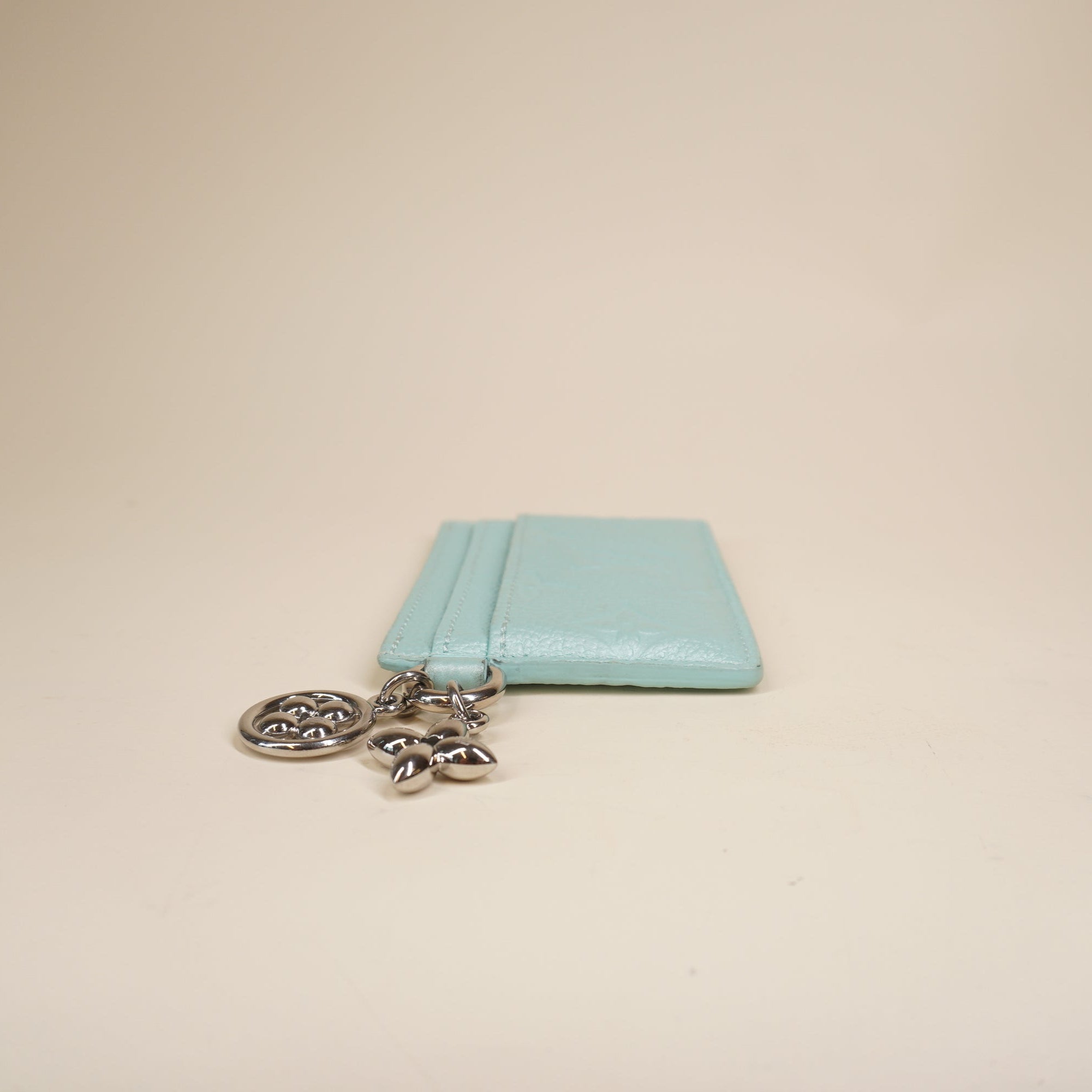 PRE-OWNED LV Lagoon Turquoise Empreinte Monogram LV Charms Card Holder Pearly