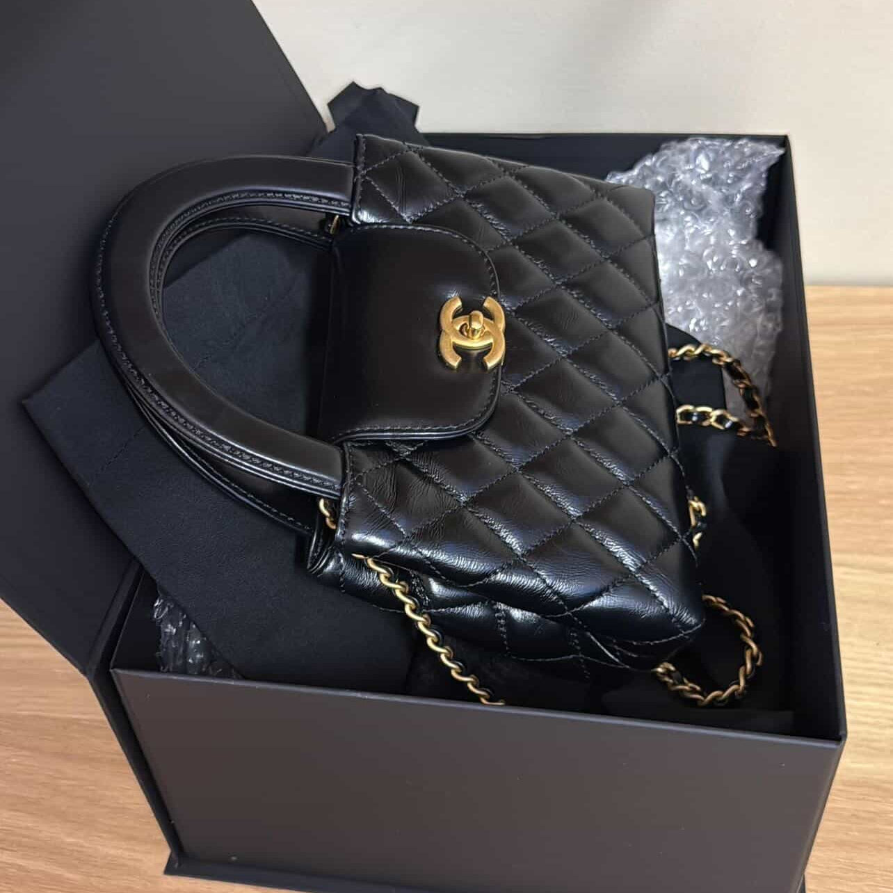 PRE-OWNED CC Shiny Aged Calfskin Quilted Nano Kelly Shopper Black