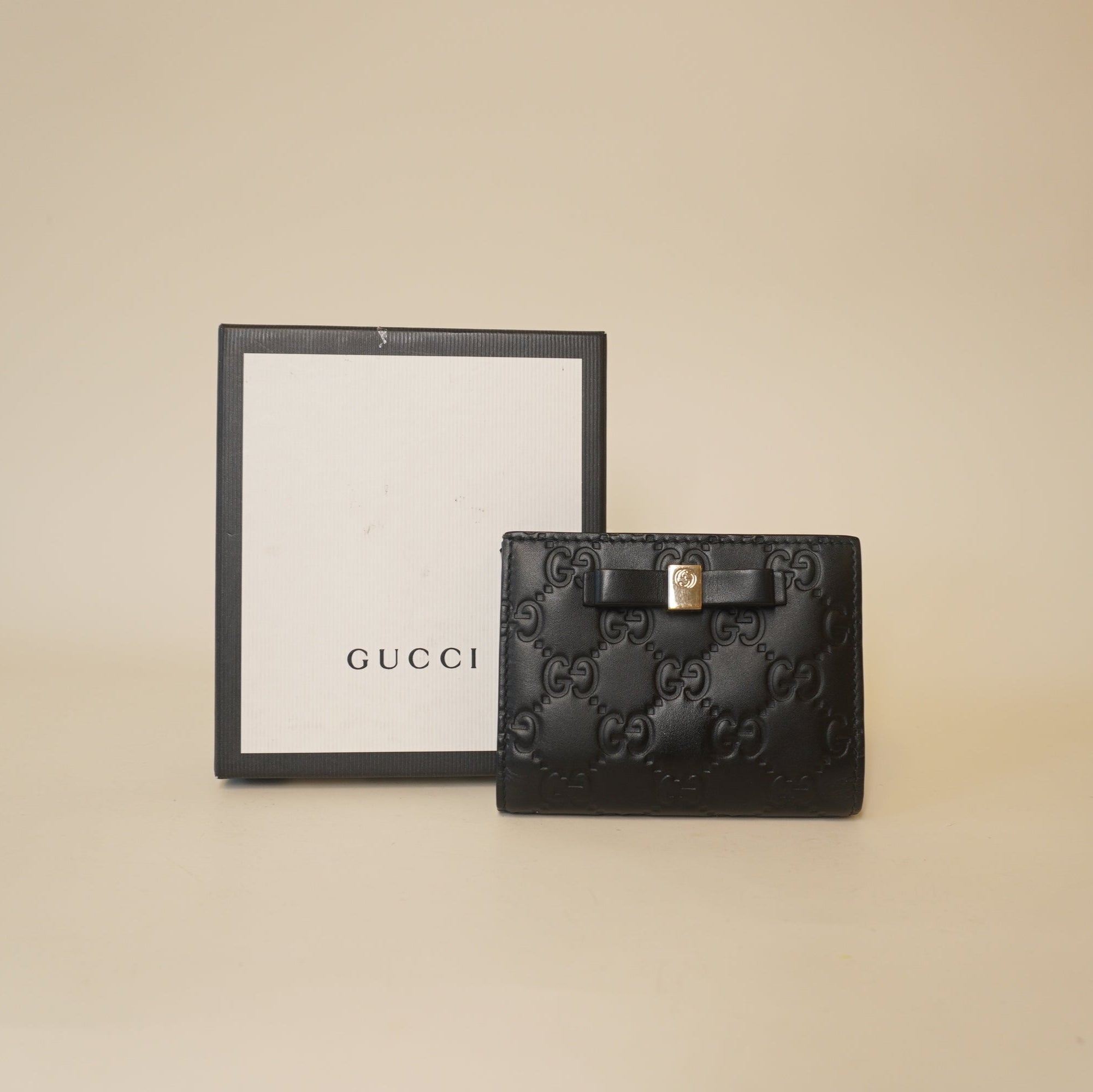 PRE-OWNED GG Black Guccissima Bow Bifold Wallet