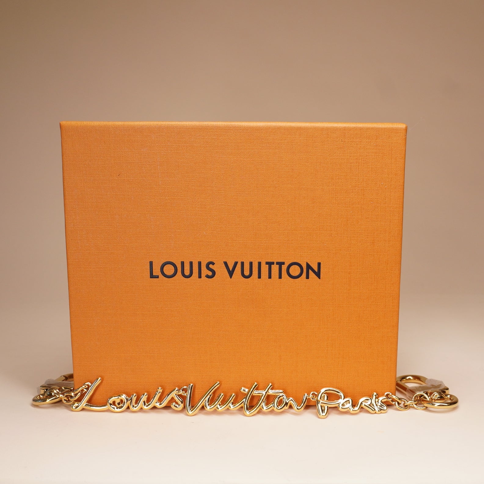 PRE-OWNED Metal LV Script Chain Bag Charm Gold Tone