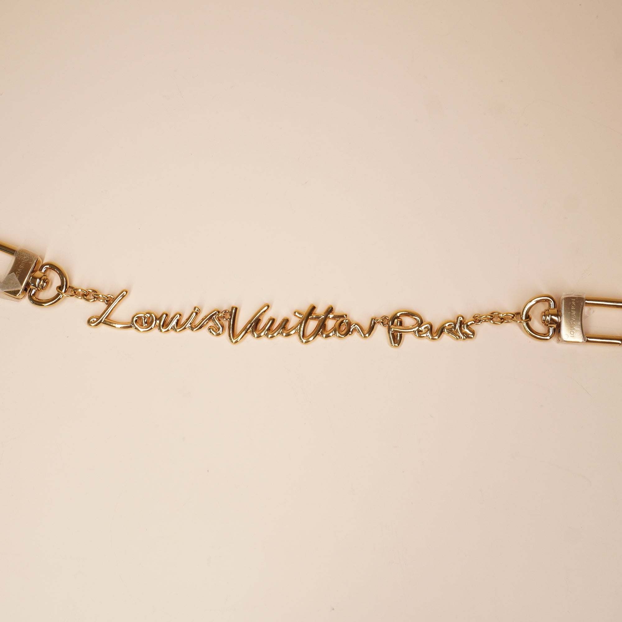 PRE-OWNED Metal LV Script Chain Bag Charm Gold Tone