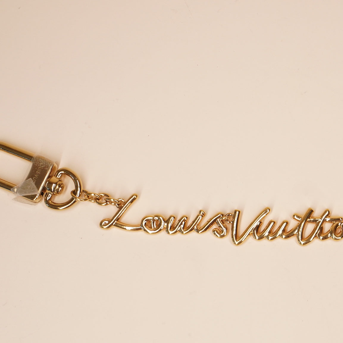 PRE-OWNED Metal LV Script Chain Bag Charm Gold Tone