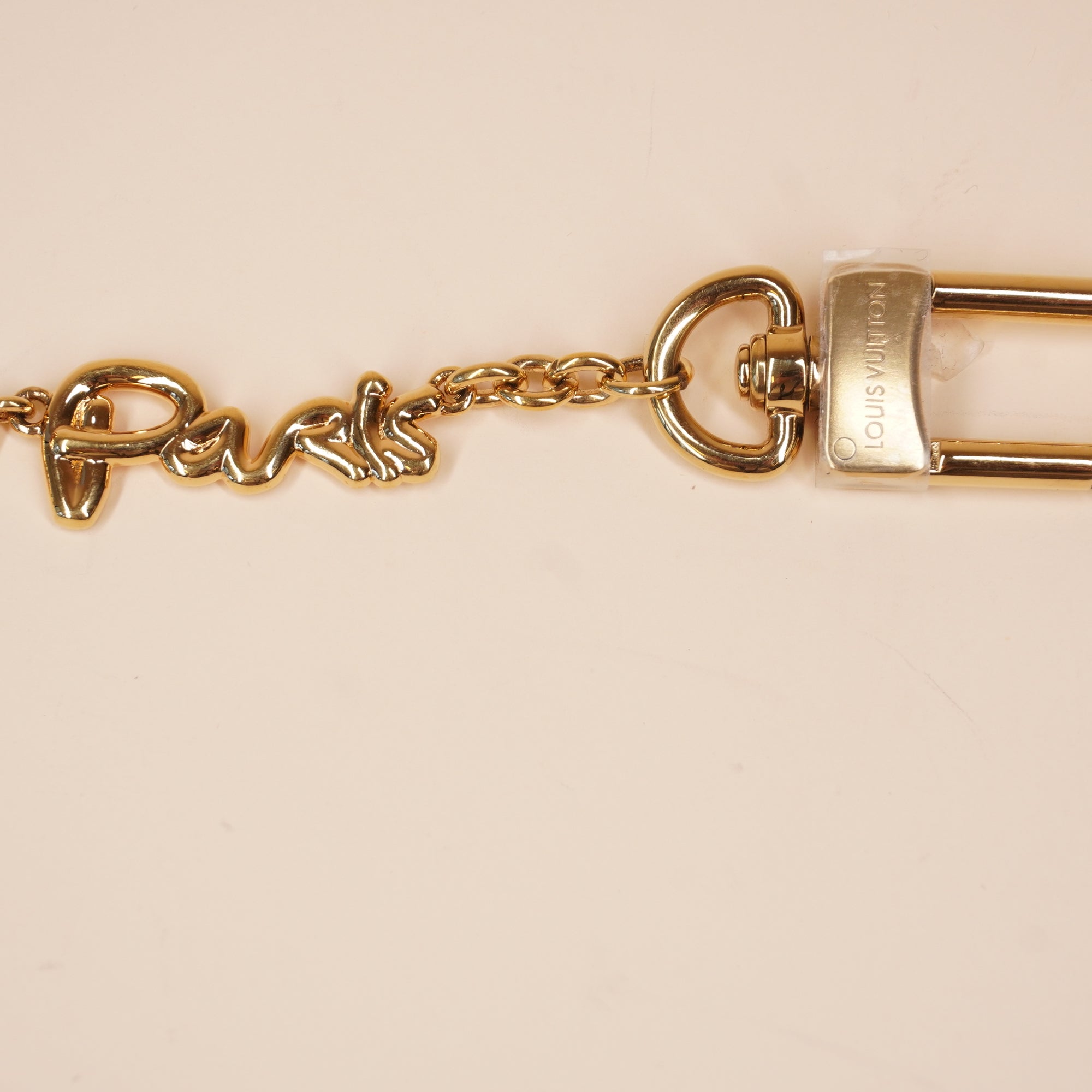 PRE-OWNED Metal LV Script Chain Bag Charm Gold Tone