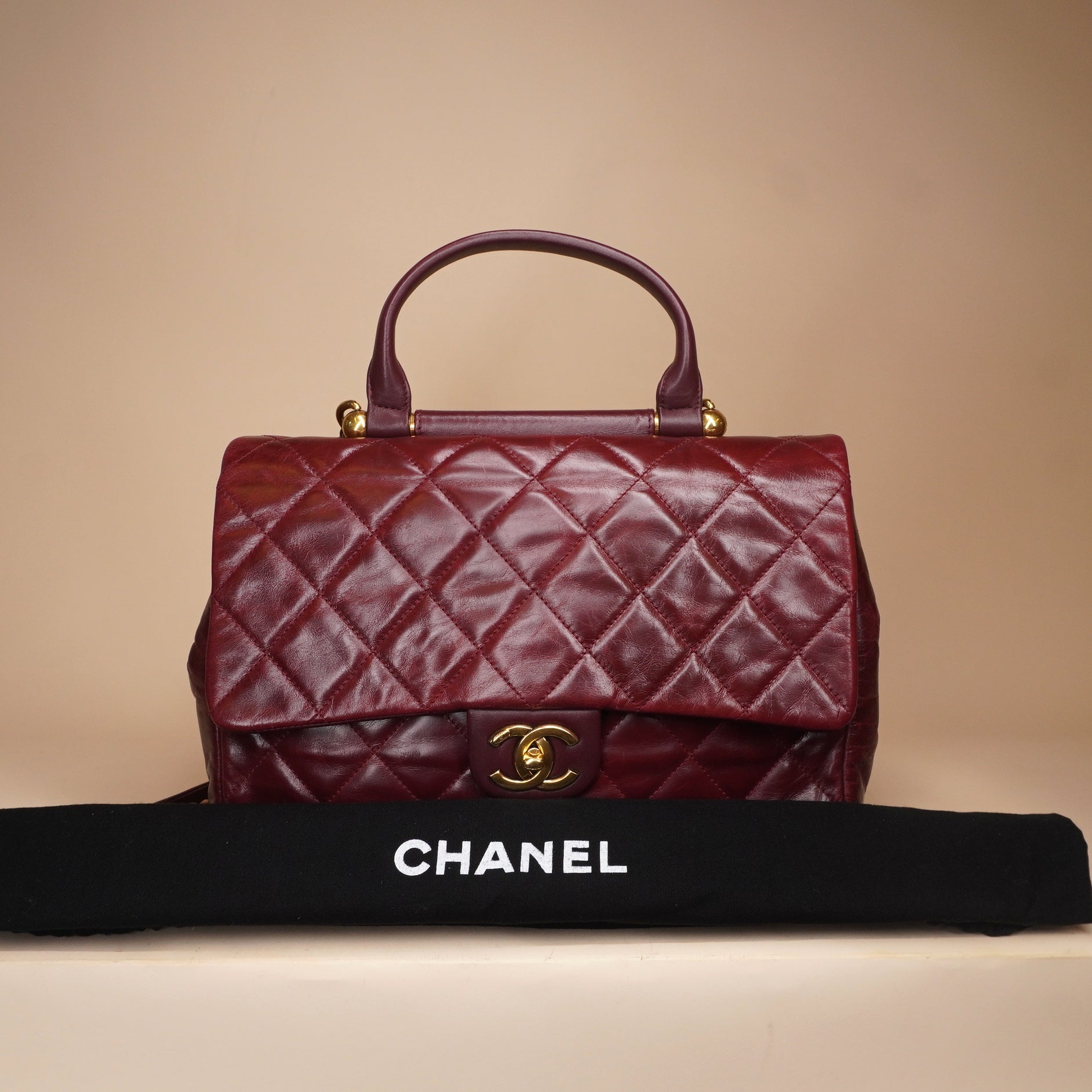 PRE-OWNED CC Burgundy Aged Leather Gold Bar Top Handle Bag