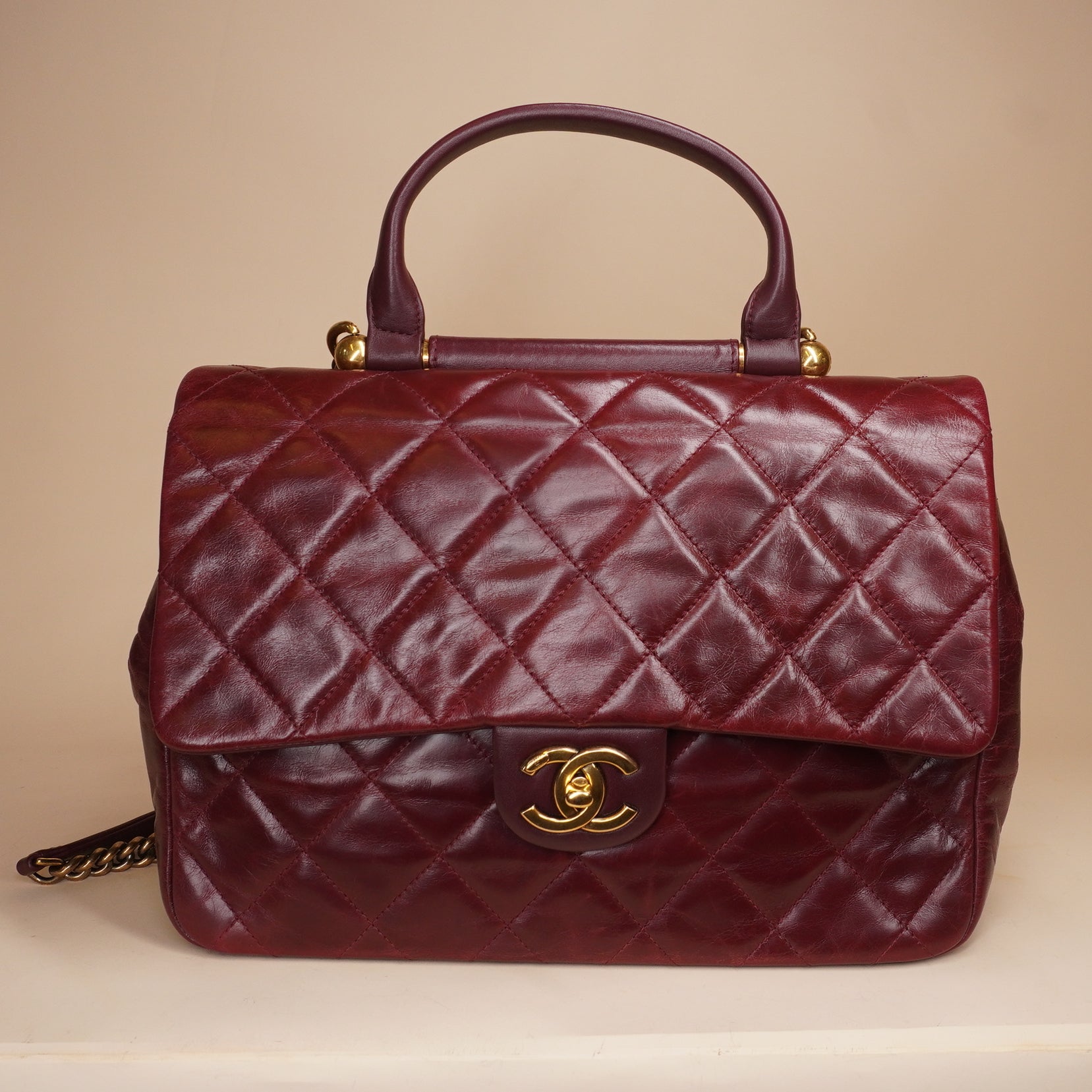 PRE-OWNED CC Burgundy Aged Leather Gold Bar Top Handle Bag