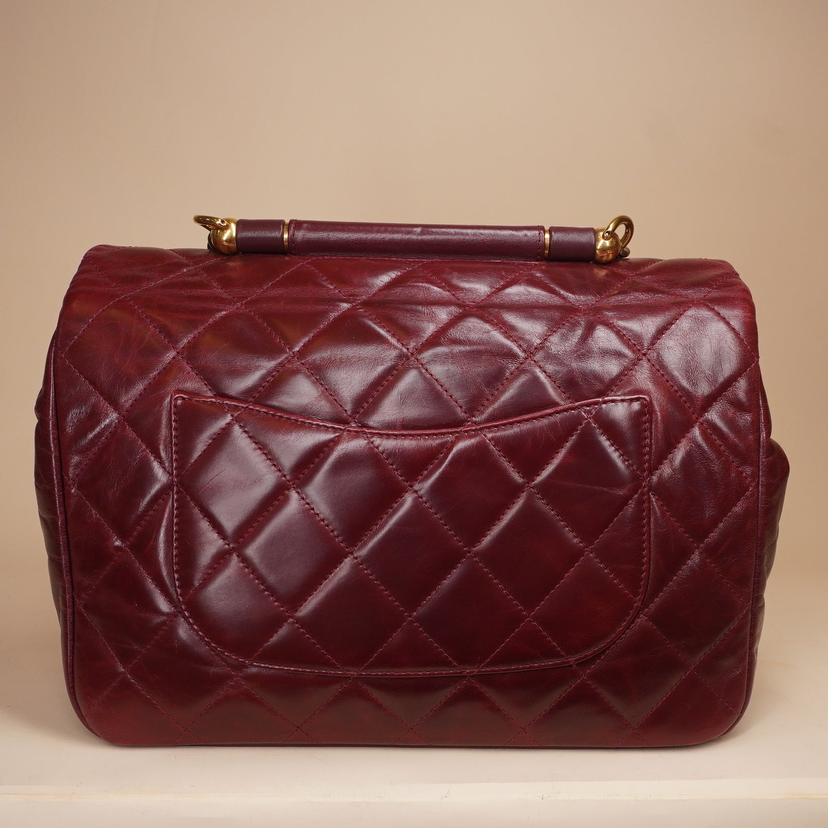PRE-OWNED CC Burgundy Aged Leather Gold Bar Top Handle Bag