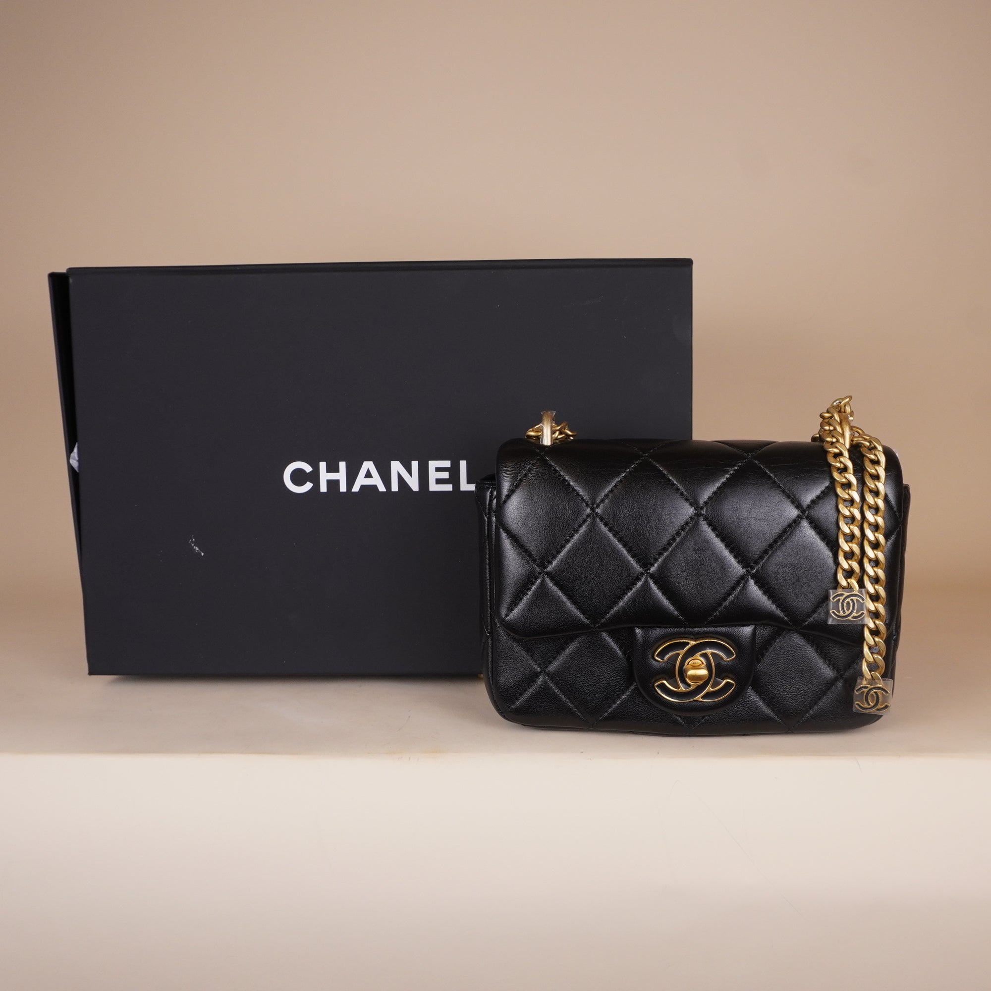 PRE-OWNED Black Quilted Lambskin Mini Flap Bag Gold and Enamel Hardware
