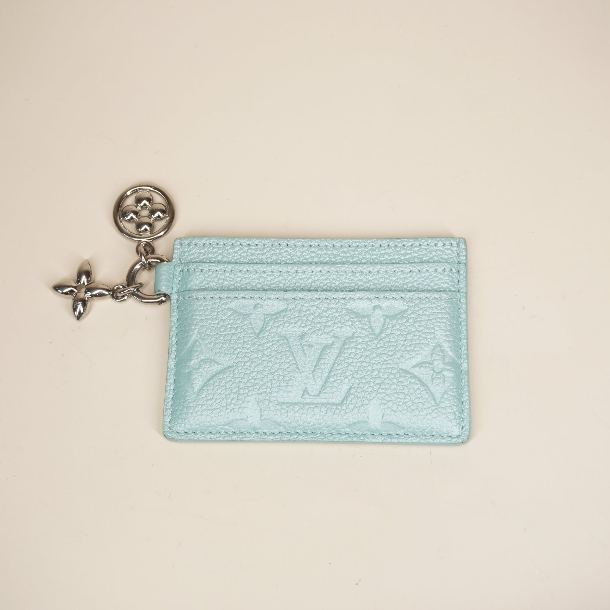 PRE-OWNED LV Lagoon Turquoise Empreinte Monogram LV Charms Card Holder Pearly