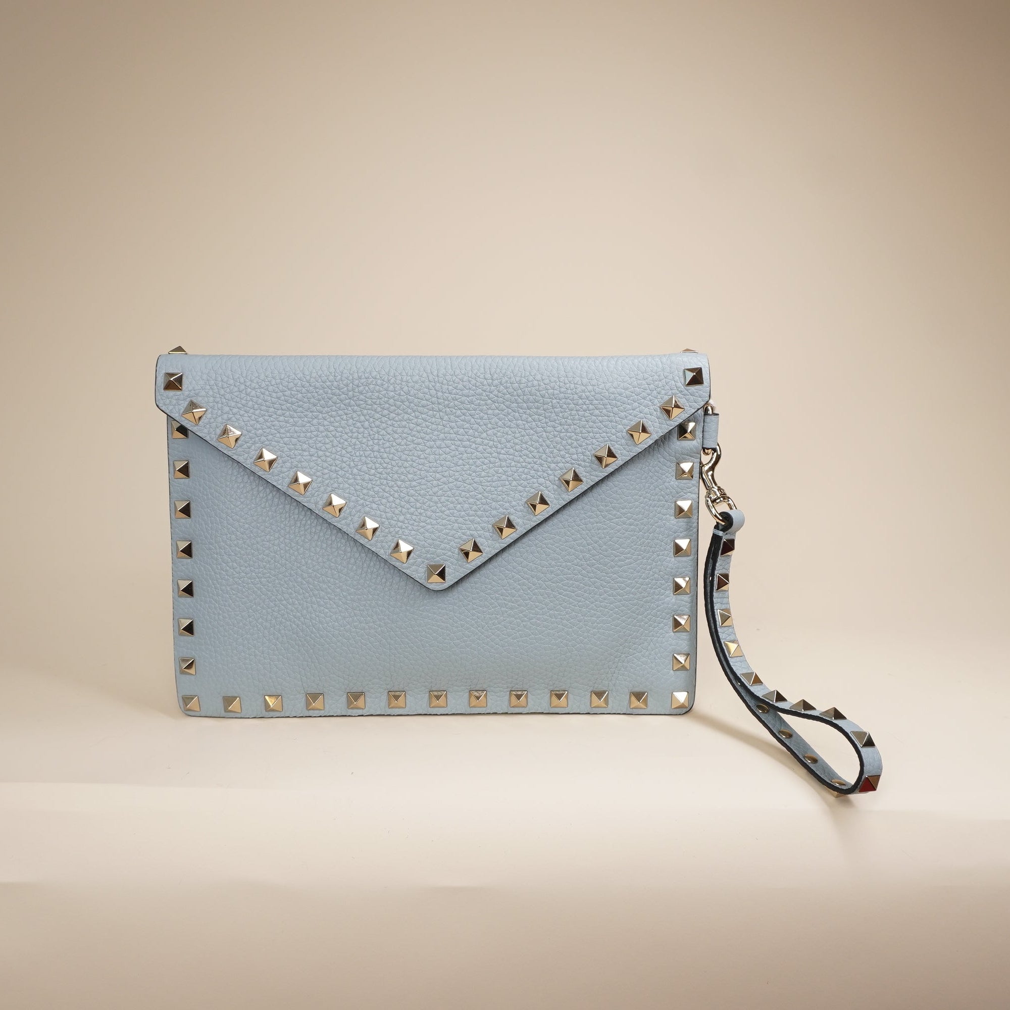 PRE-OWNED Light Blue Rockstud Grainy Calfskin Pouch