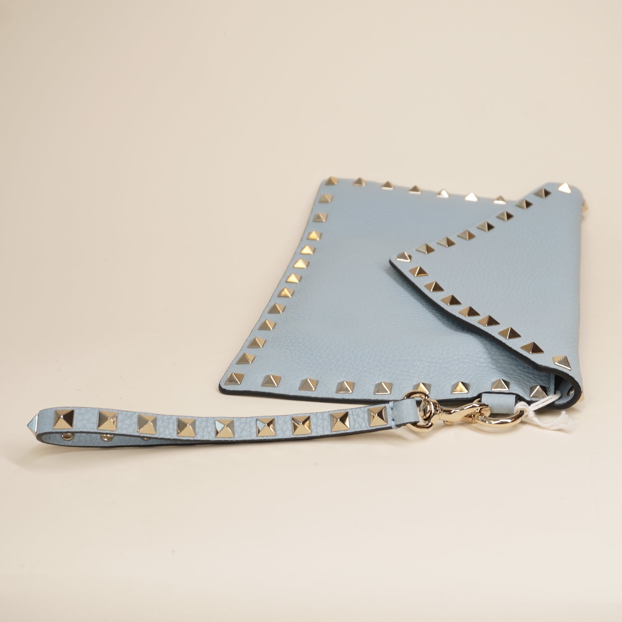 PRE-OWNED Light Blue Rockstud Grainy Calfskin Pouch
