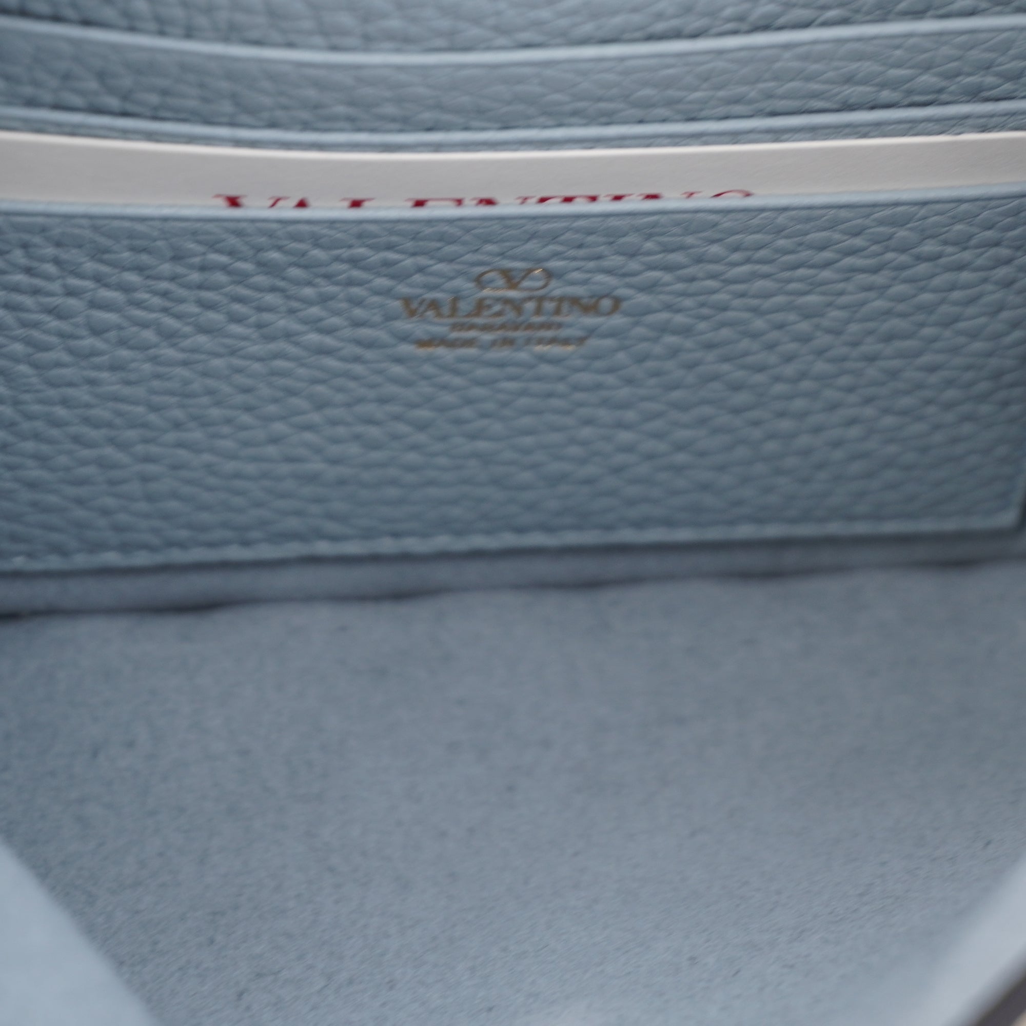 PRE-OWNED Light Blue Rockstud Grainy Calfskin Pouch