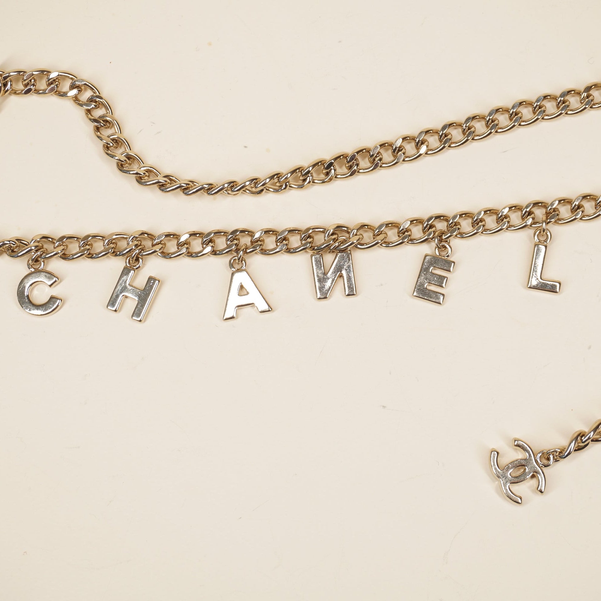 PRE-OWNED CC Letter Drop Chain Belt Light Gold Tone