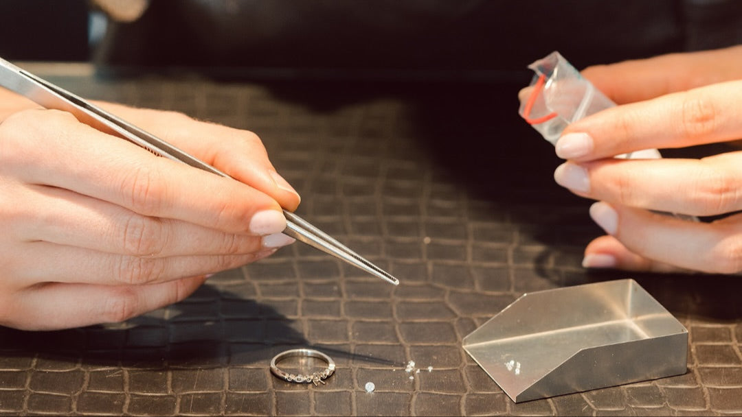 Person working with jewelry on a table