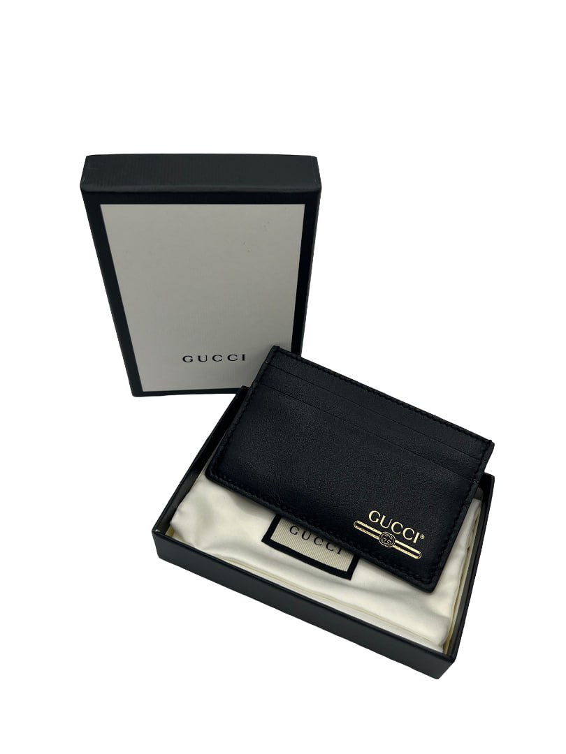GUCCI - Tarjetero de piel negra y dorada